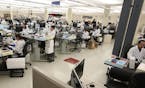 Lab workers log in specimen samples at the Mayo Clinic Superior Drive facility in Rochester in early March.