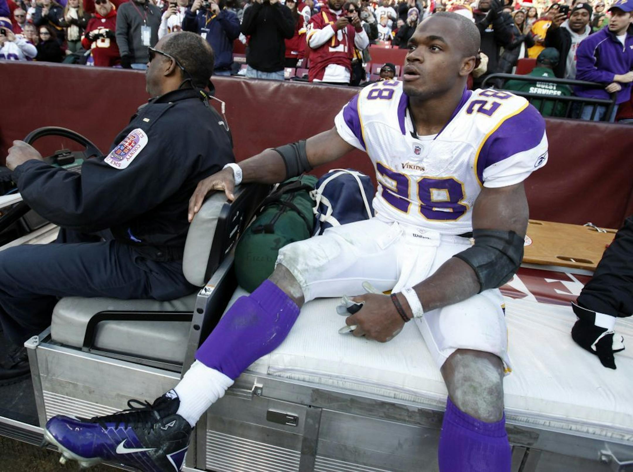 Minnesota Vikings running back Adrian Peterson (28) was carted off the field after injuring his knee in the third quarter.