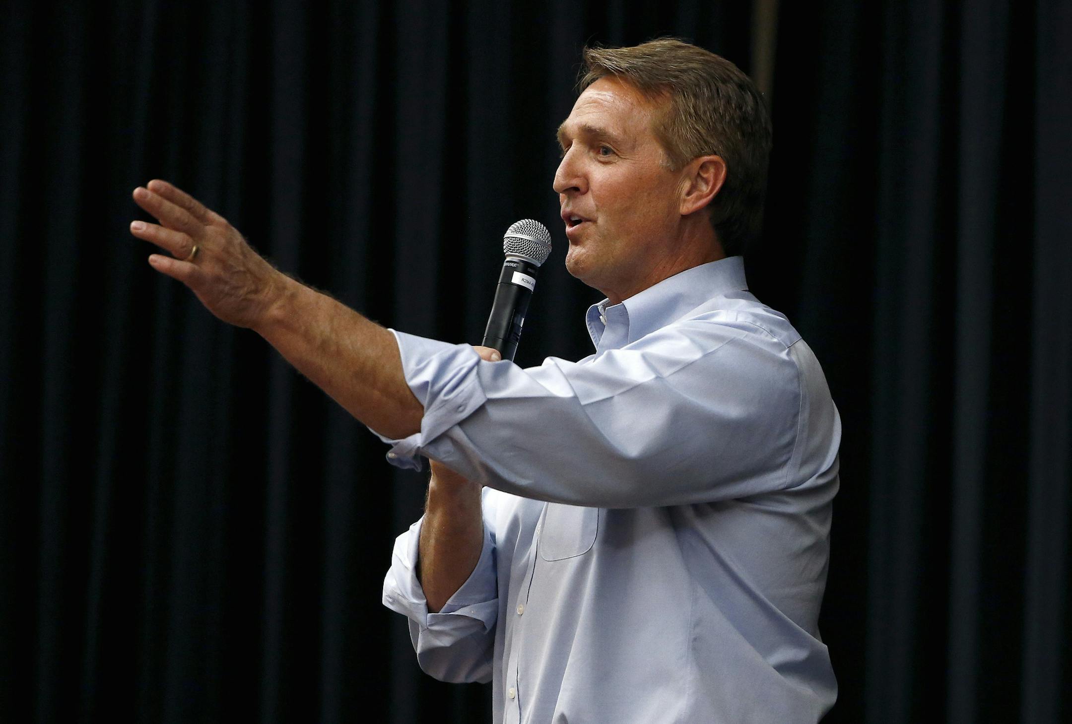 FILE- In this April 13, 2017, file photo, Arizona Republican Sen. Jeff Flake takes a question from the audience during a town hall in Mesa, Ariz. The debut of Flake's book "Conscience of a Conservative" goes on sale on Tuesday, Aug. 1. (AP Photo/Ross D. Franklin, File)