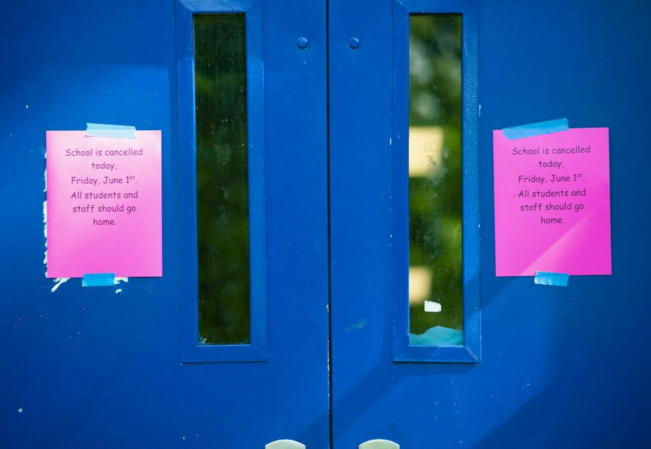 A sign on the entrance at Minneapolis Washburn High School informs students and staff of school cancellation on Friday, June 1, 2018.