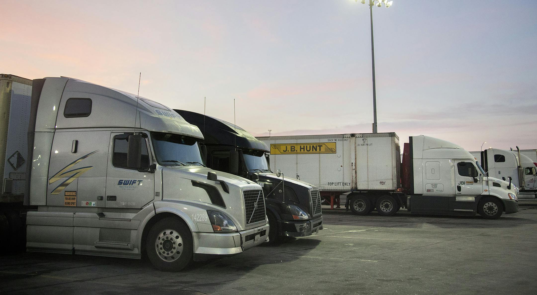 FILE &#xf3; A Swift Transportation Company truck at the Iowa 80 Truckstop in Walcott, Iowa, Oct. 8, 2015. Knight Transportation and Swift Transportation Company, two American trucking companies, said they would combine in an all-stock deal as they seek scale amid pricing pressure in the trucking sector. (KC McGinnis/The New York Times)