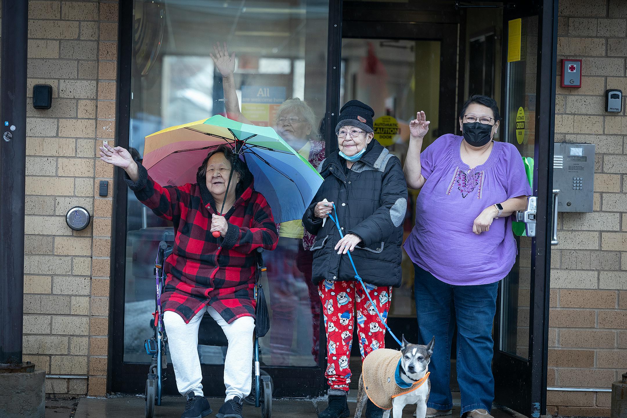 Folks from an apartment building stood outside to watch and wave as hundreds march during the annual Missing and Murdered Indigenous Women's rally and march at the East Phillips Park Cultural & Community Center, in Minneapolis, Minn., on Tuesday, Feb. 14, 2023.  Minnesota's movement to solve the cases of hundreds of missing and murdered Indigenous women and girls hit a milestone last year with the opening of a first-in-the-nation office tasked with systemically trying to fix the problem. Minnesota's Native women legislators reflected on where the movement goes from here during the annual Missing and Murdered Indigenous Women's march in Minneapolis.   ] Elizabeth Flores • liz.flores@startribune.com