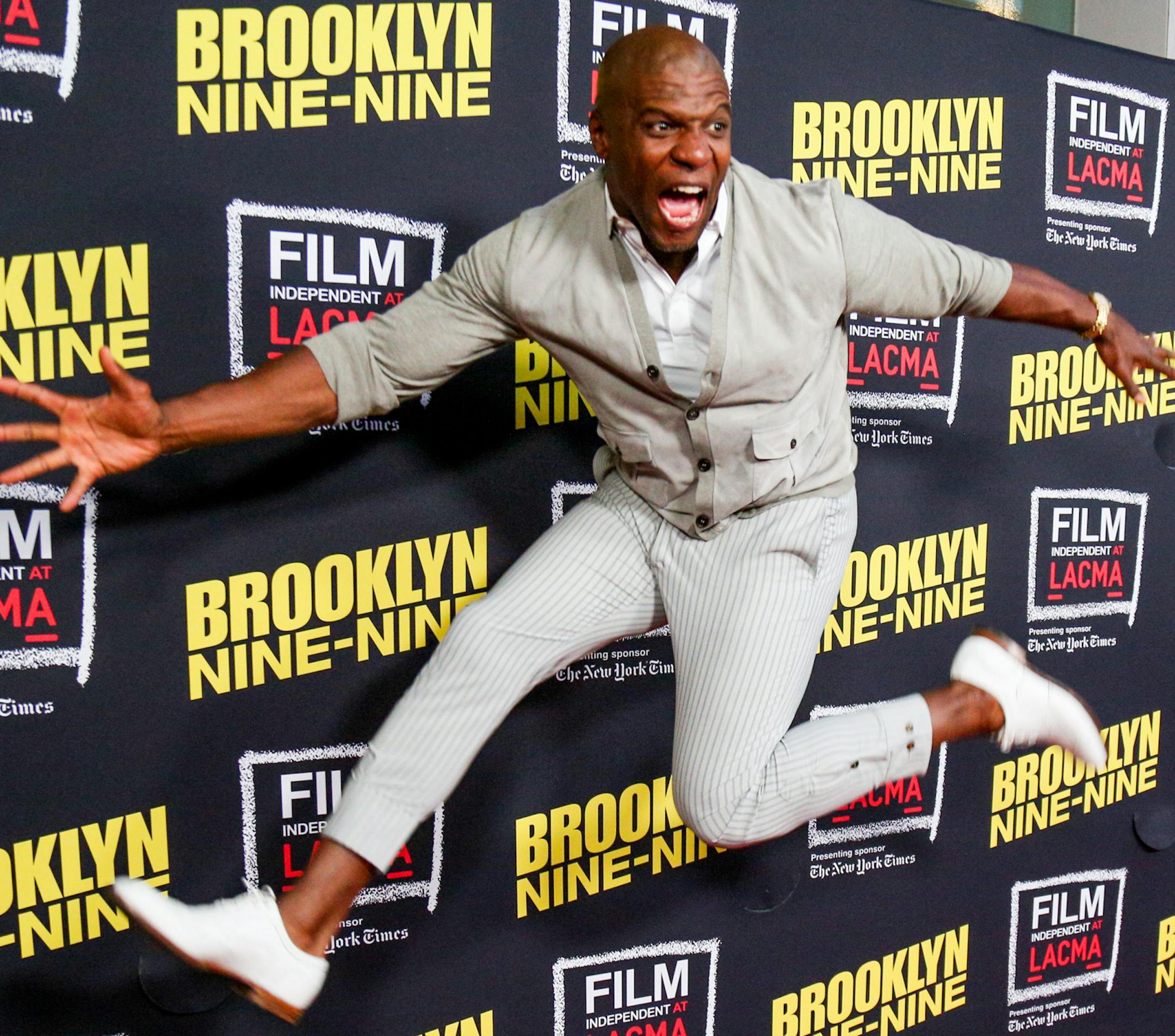 Terry Crews jumps in the air as he arrives at An Evening With "Brooklyn Nine-Nine" at Bing Theatre on Thursday, May 7, 2015, in Los Angeles.(Photo by Rich Fury/Invision/AP)