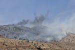 Smoke rise from fires that erupted at open hills by Israeli shelling, in Chebaa, a Lebanese town near the border with Israel, south Lebanon, Friday, J