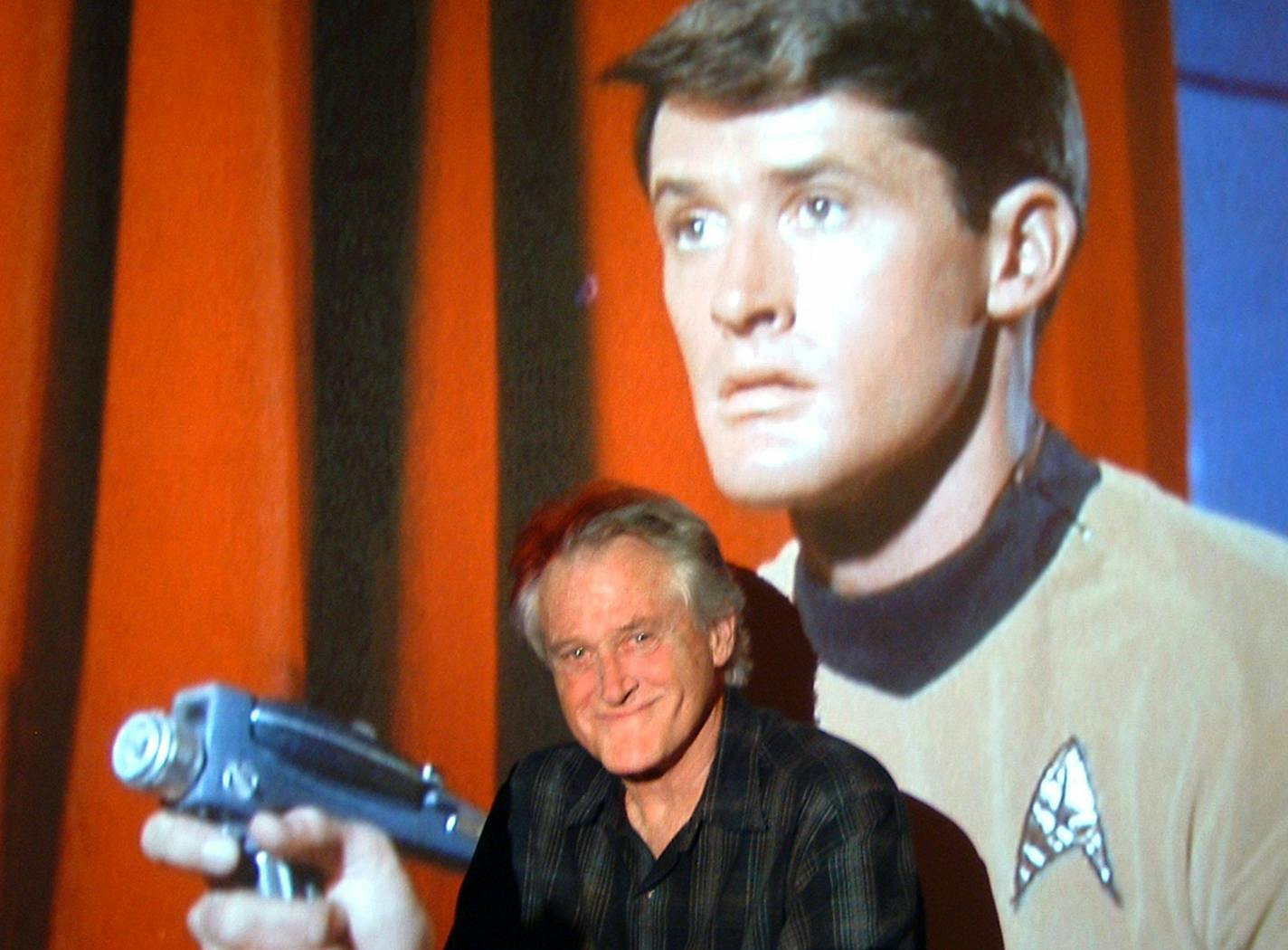 Credit: Randy Salas, Star Tribune Caption: St. Cloud actor Bruce Hyde posed next to a projection of his appearance on the classic 1960s "Star Trek" TV series to mark the release of the episode on DVD in 2004. Hyde died Tuesday at 74. ORG XMIT: MIN1510161330161084