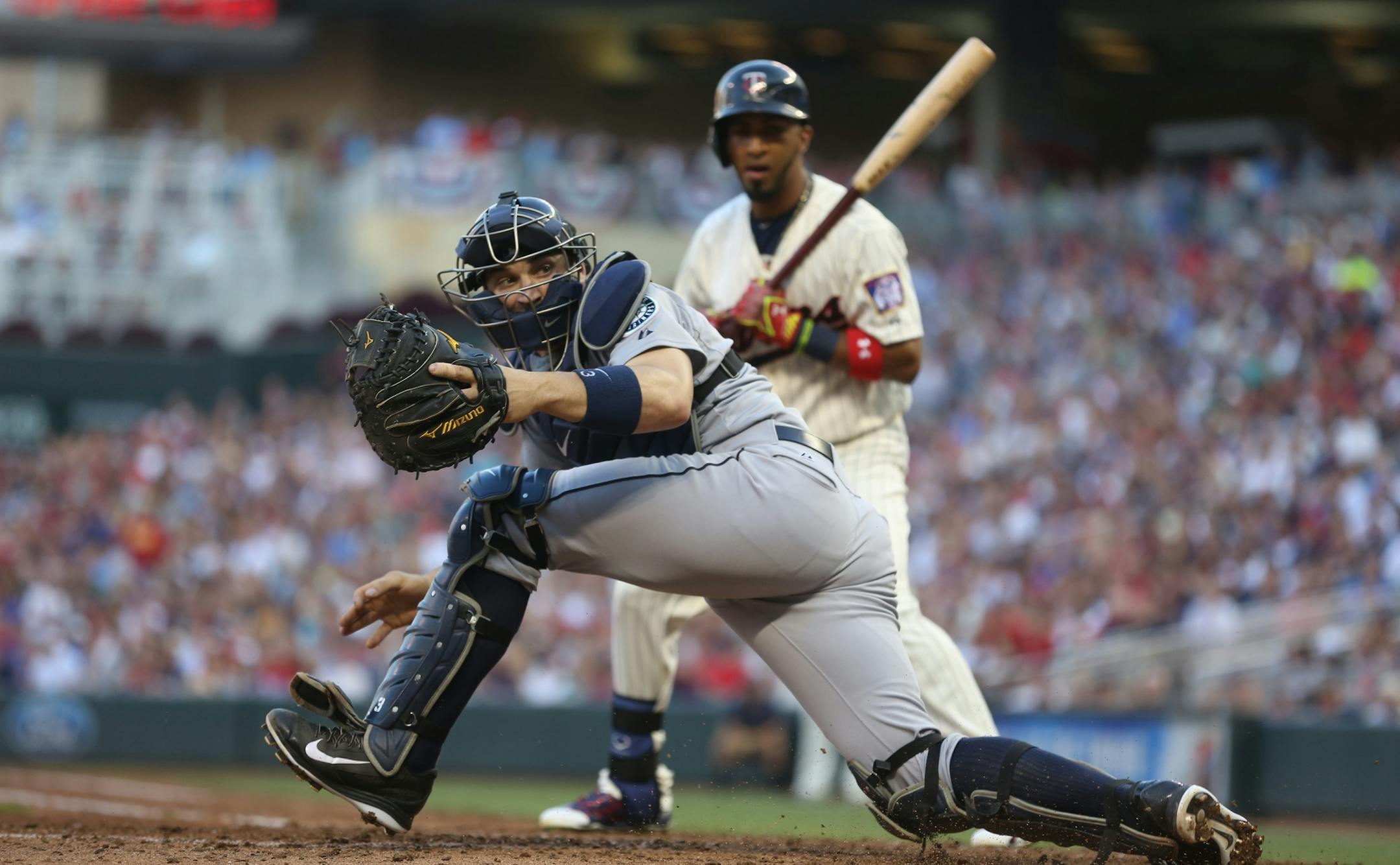 Seattle's Mike Zunino watched a wild pitch go by that scored Twins Trevor Plouffe in the third inning.