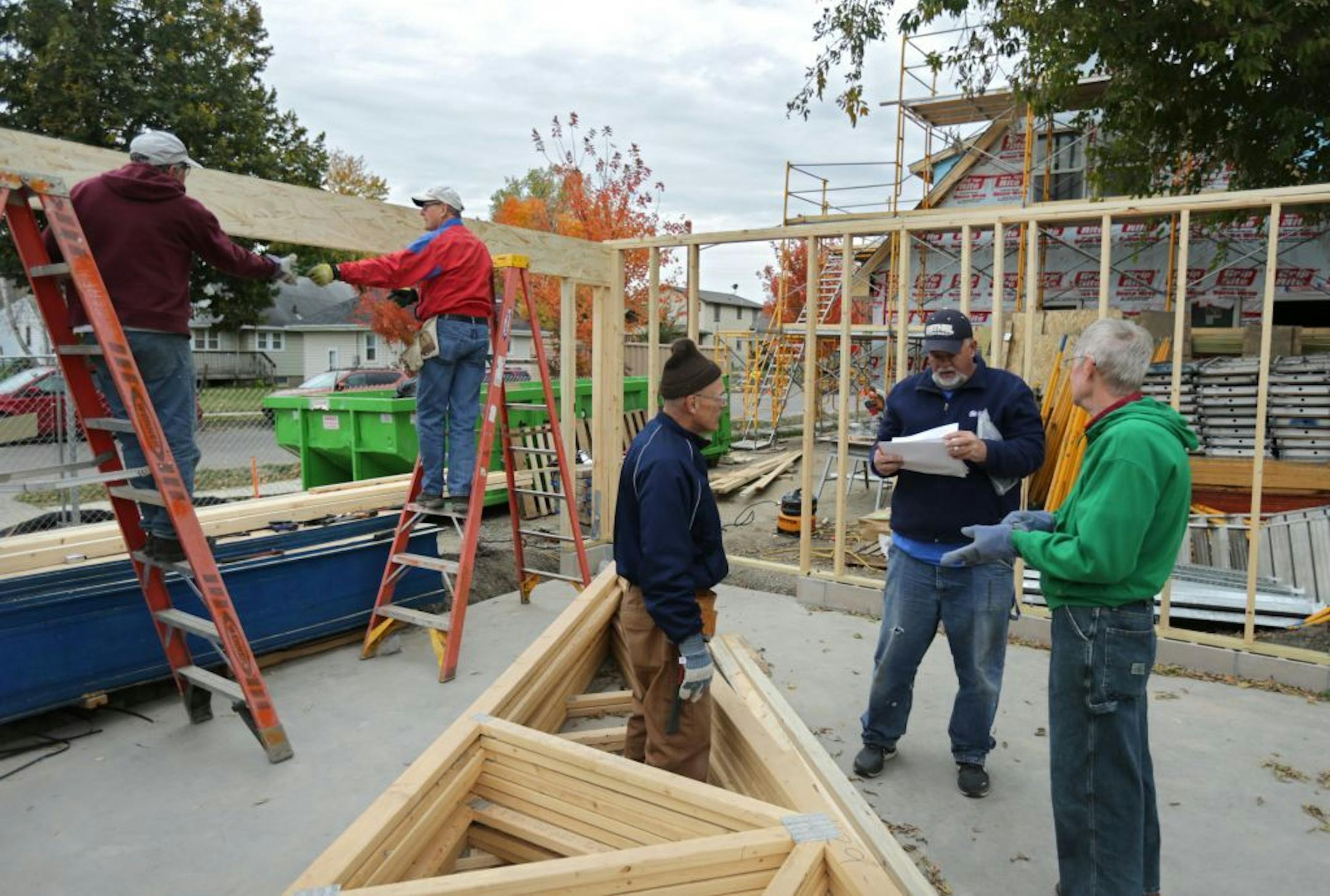 Habitat for Humanity, renowned for building new houses, is moving into the fixer upper business. Here, a team works on a new house garage at 2700 Morgan Ave. N in Minneapolis Tuesday afternoon.