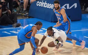 Timberwolves center Naz Reid (11) loses control of the ball as Oklahoma City Thunder forward Jalen Williams (8) gains possession in the second quarter
