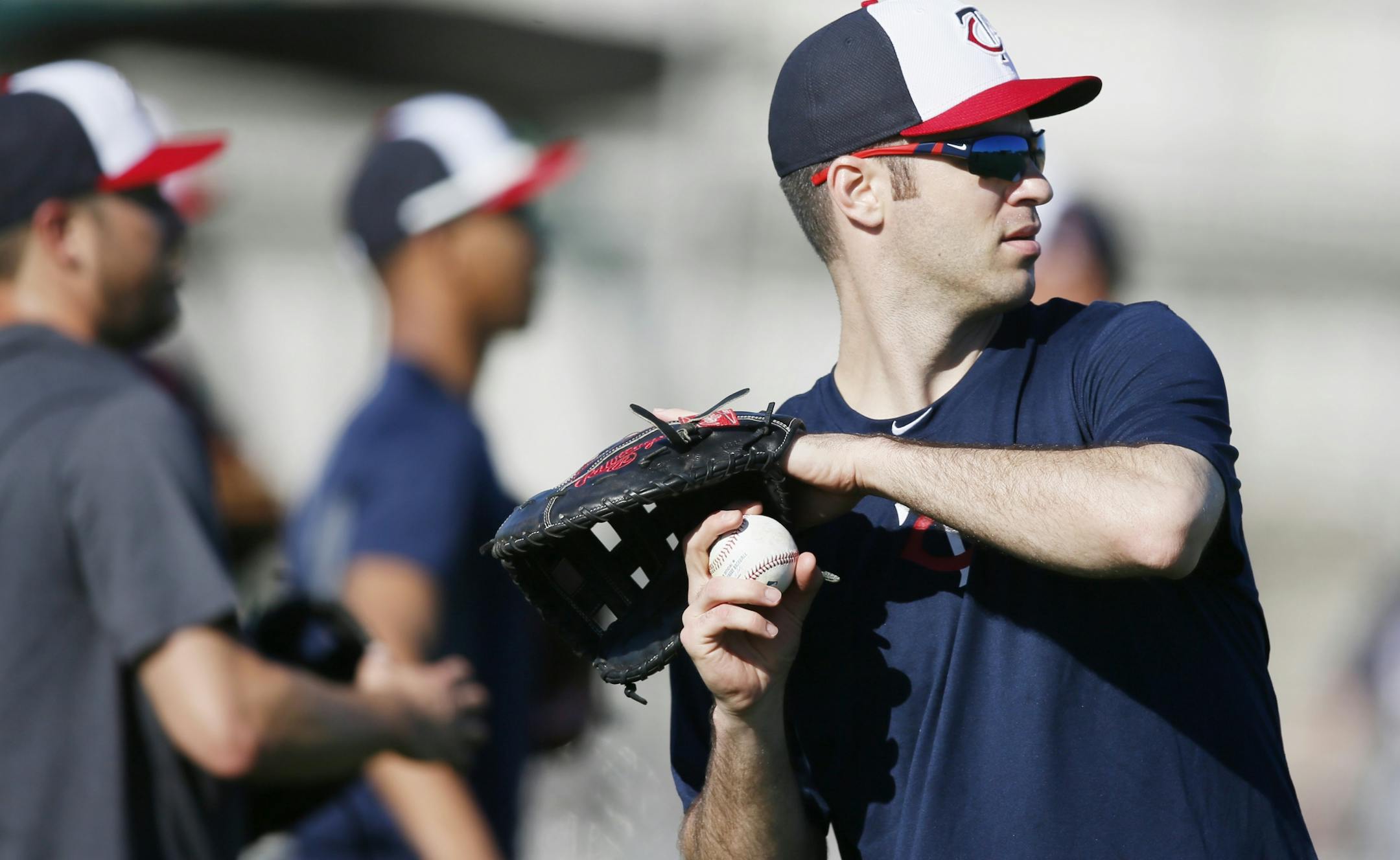 Twins first baseman Joe Mauer warmed up during spring training practice Feb 17, 2014, in Fort Myers, Fla.