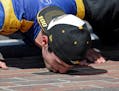 Alexander Rossi kisses the bricks on the start/finish line after wining the 100th running of the Indianapolis 500 auto race at Indianapolis Motor Spee
