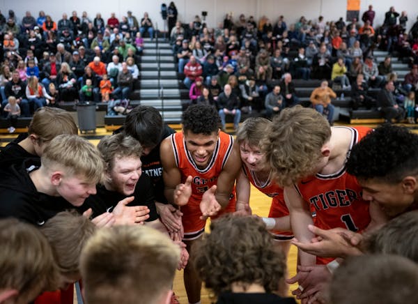 Cherry's Isaac Asuma, center, cheers in the huddle with teammates before playing Fosston Friday, Jan. 27, 2023 at Cherry High School in Cherry, Minn.