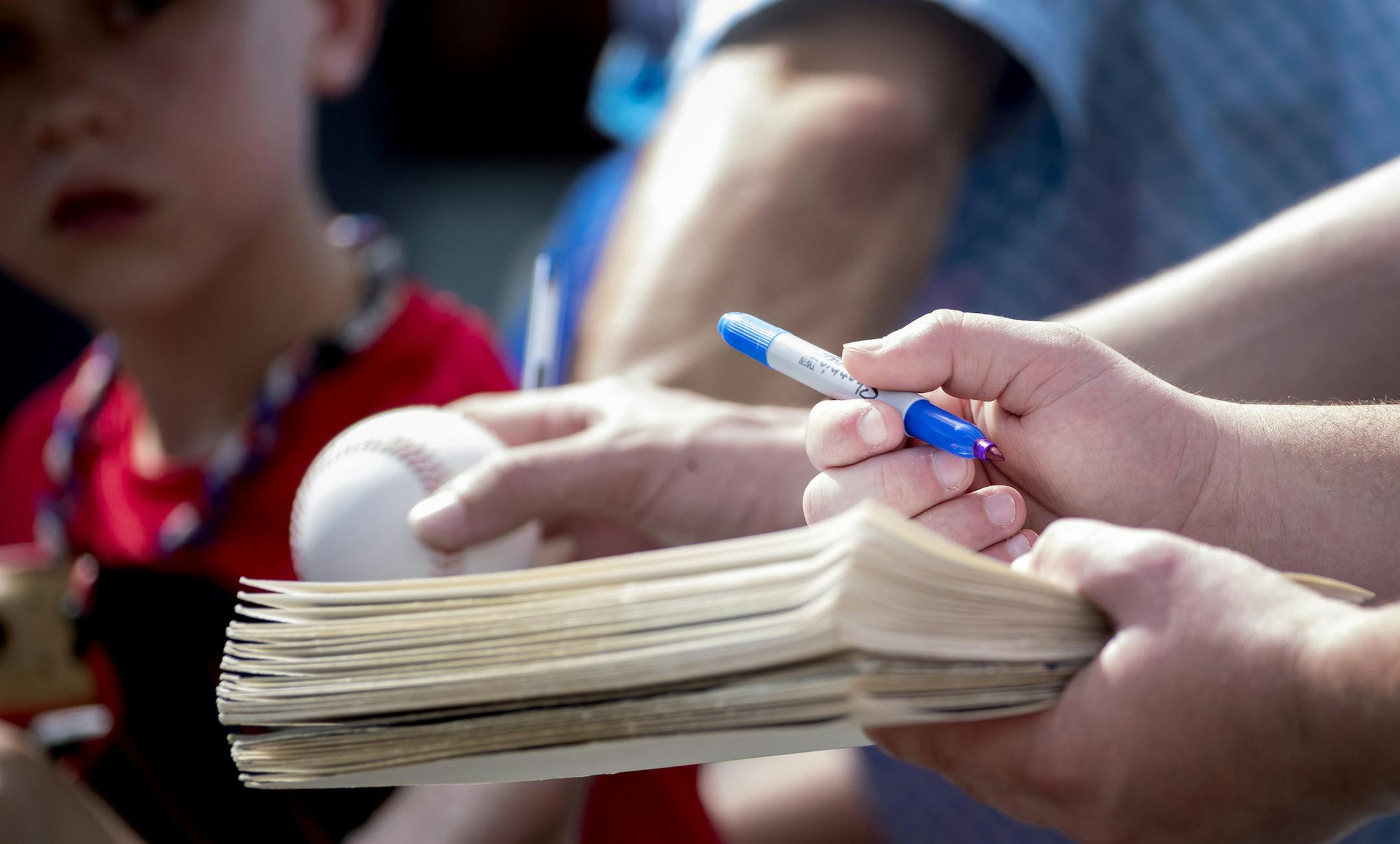 Fans held out items in hope of getting an autograph at the first day of practice for position players. ] CARLOS GONZALEZ • cgonzalez@startribune.com – Fort Myers, FL – February 17, 2020, CenturyLink Sports Complex, Hammond Stadium, Minnesota Twins, Spring Training