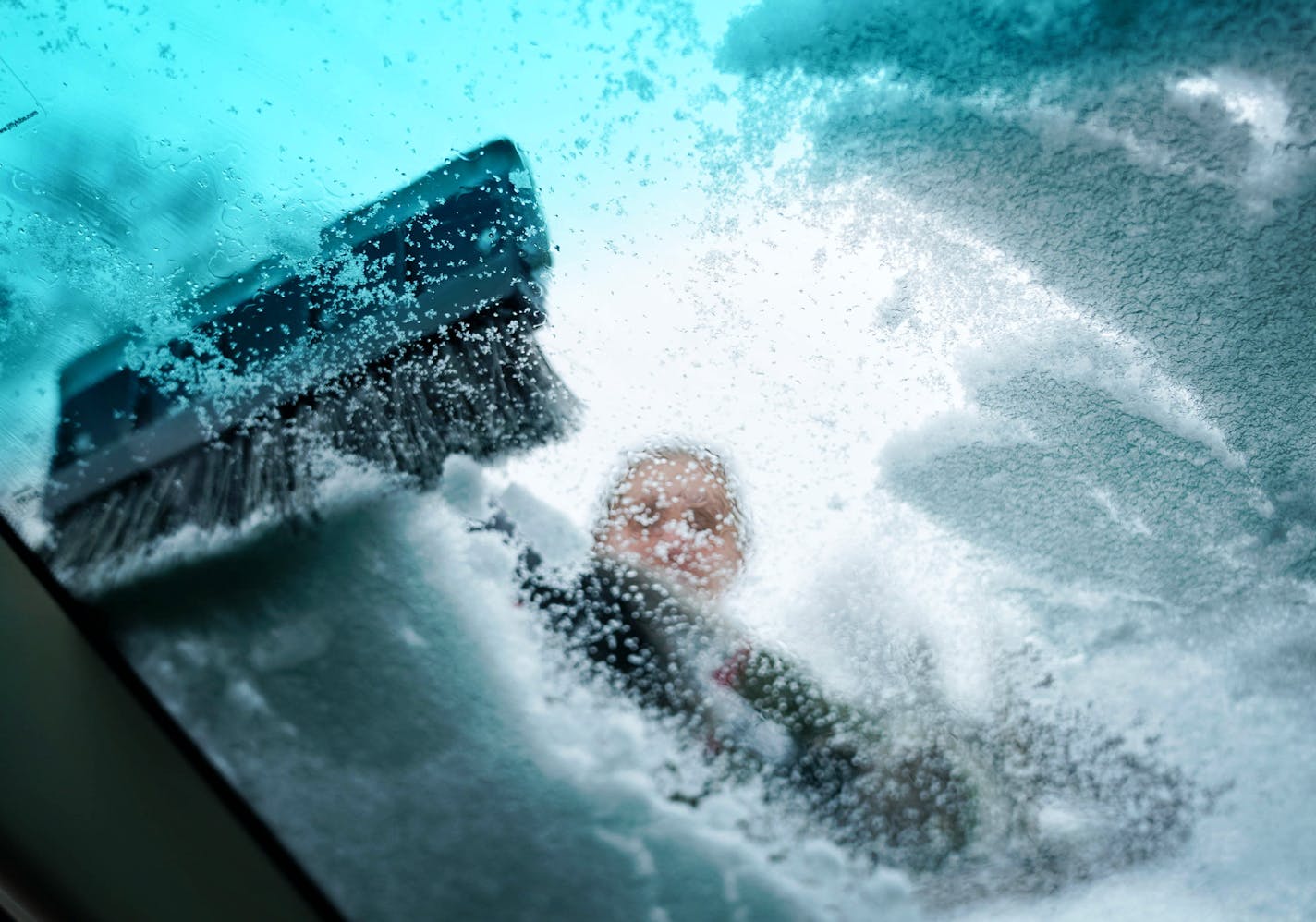 Claire Radtke cleaned the sloppy, wet snow from her windshield Tuesday afternoon before heading out to run errands in St. Paul.