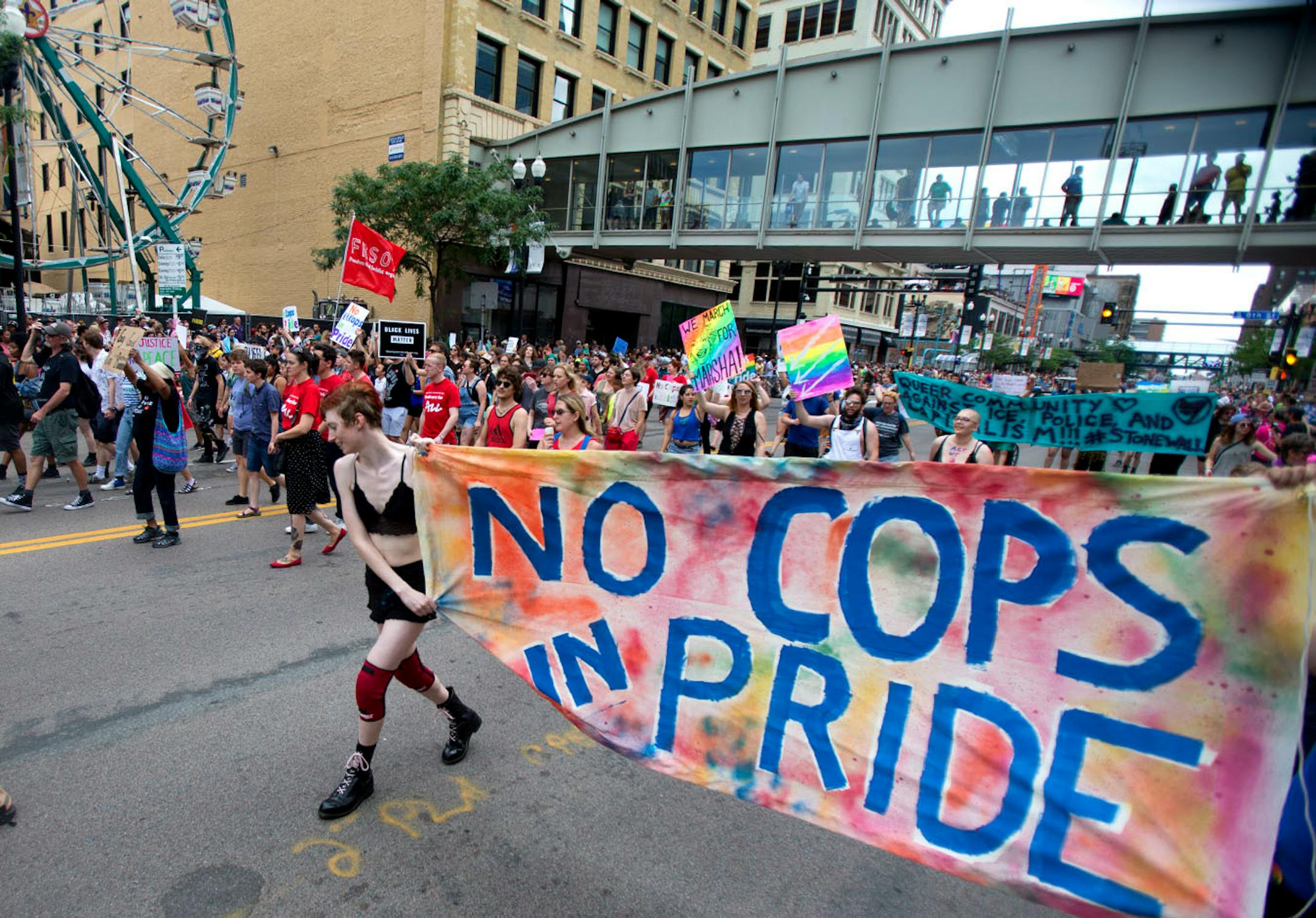 Protestors marched ahead of the pride parade on Sunday to call attention to misconduct by police and the death of black community members.