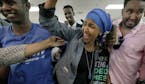Somali activist Ilhan Omar is greeted by supporters at Kalsan Tuesday, Aug. 9, 2016, in Minneapolis. Omar defeated 22-term Rep. Phyllis Kahn in Tuesda
