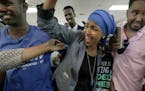 Somali activist Ilhan Omar is greeted by supporters at Kalsan Tuesday, Aug. 9, 2016, in Minneapolis. Omar defeated 22-term Rep. Phyllis Kahn in Tuesda