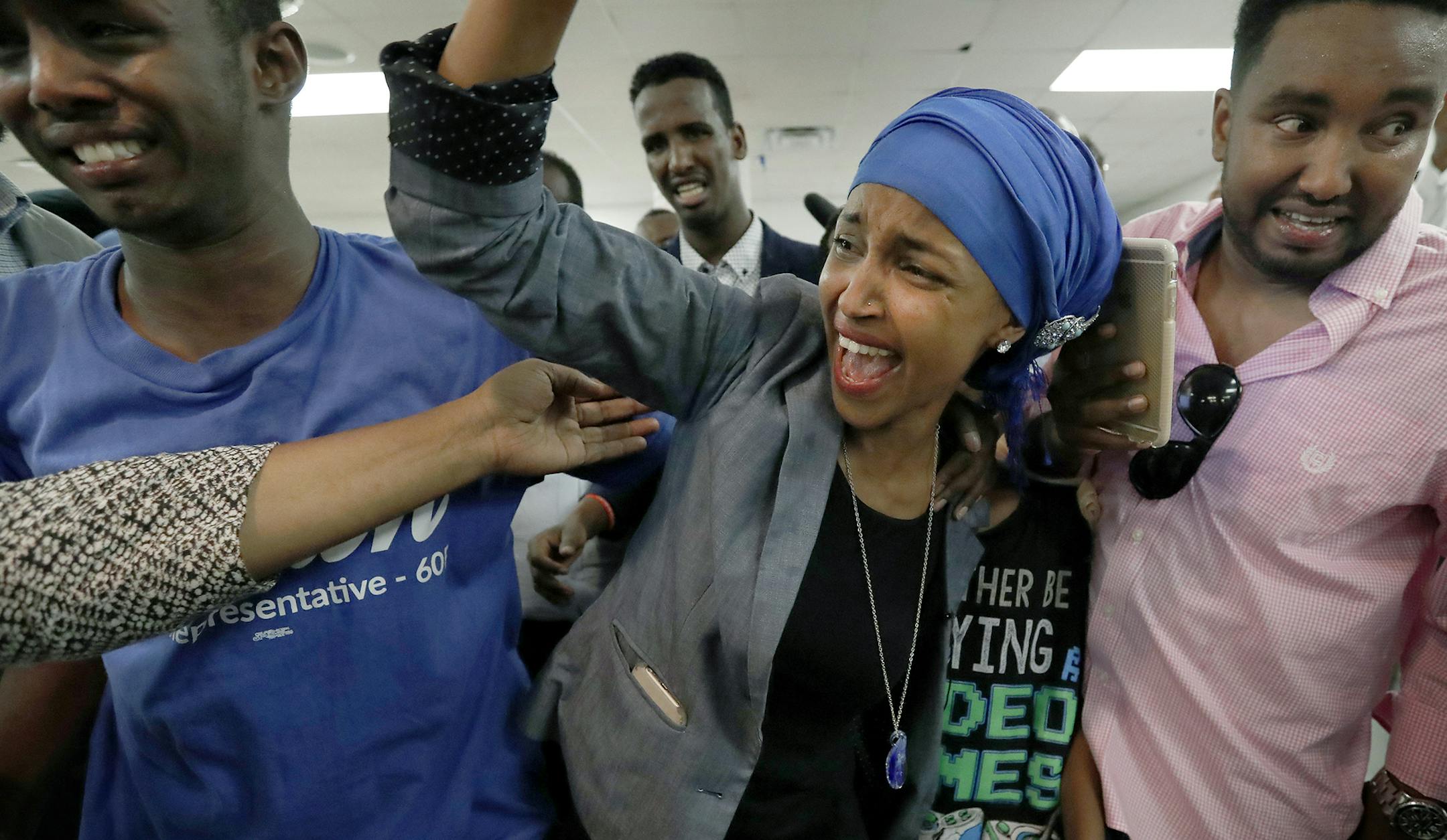 Somali activist Ilhan Omar is greeted by supporters at Kalsan Tuesday, Aug. 9, 2016, in Minneapolis. Omar defeated 22-term Rep. Phyllis Kahn in Tuesday's nominating contest in the heavily Democratic Minneapolis district. (Carlos Gonzalez/Star Tribune via AP) ORG XMIT: MIN2016081613304819