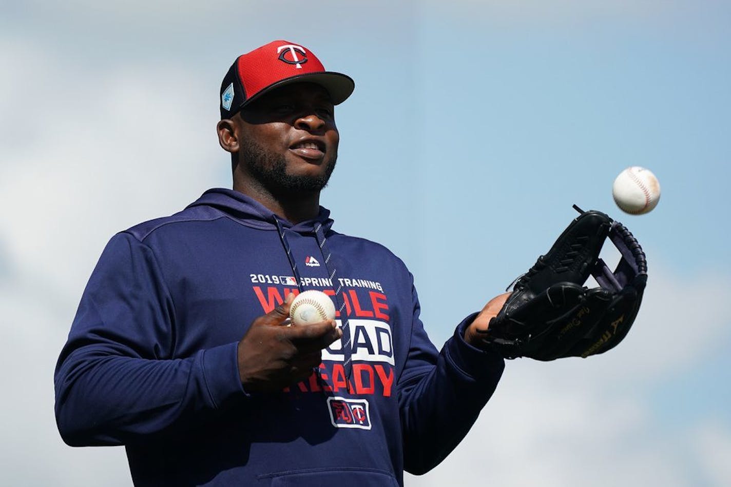 Minnesota Twins third baseman Miguel Sano (22), who sat out of fielding drills due to a cut on his right leg, fed balls to manager Rocco Baldelli during fielding drills Monday.