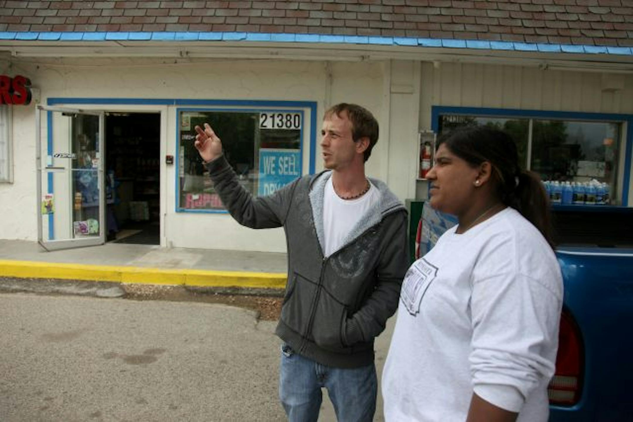 Tony Compton, left, and his sister-in-law Sunita Kreslins, took time from their day to greet and check on the store clerk at Lakeshore Market.