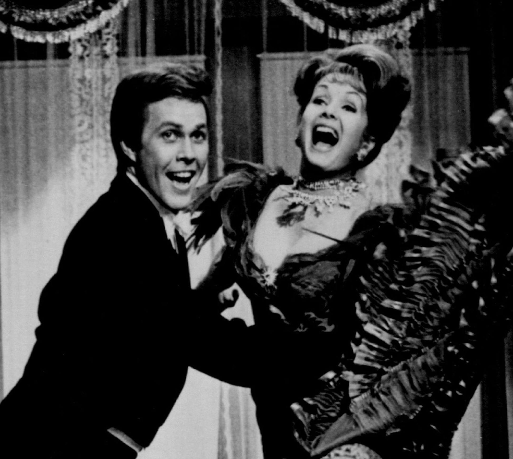 1978 Exclusive to you in your city - Debbie Reynolds portrays Molly and Harve Presnell is her husband, Leadville" Johnny Brown, in MGM's rousing musical comedy, "The Unsinkable Molly Brown," which will be presented as a color special Wednesday, Nov. 25 (7:30-10 p.m. NYT), on the NBC Television Network. NBC Television Network