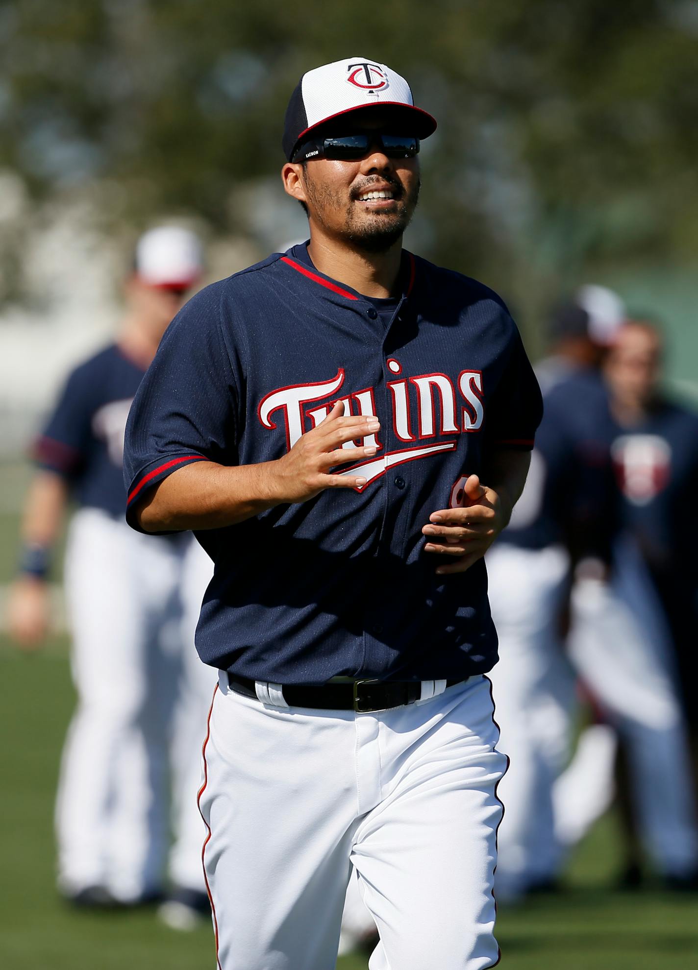 Minnesota Twins' Kurt Suzuki jogs as he warms up before a practice at baseball spring training in Fort Myers, Fla., Tuesday March 3, 2015. (AP Photo/Tony Gutierrez)