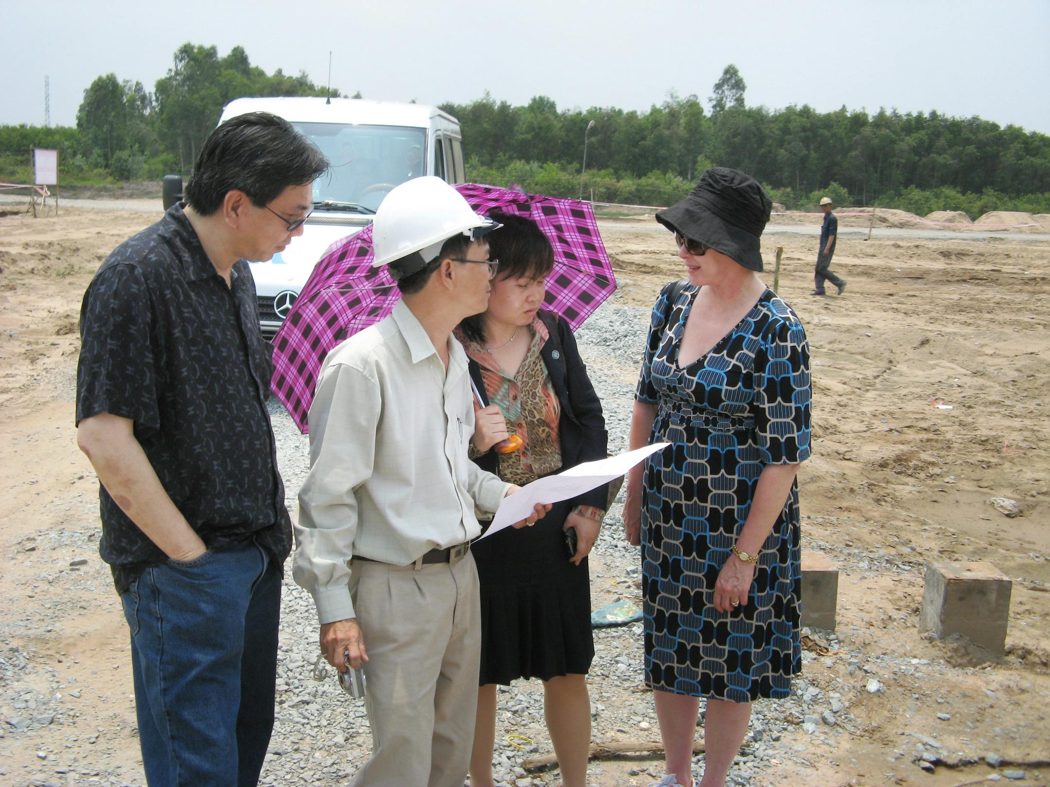 NEAL ST. ANTHONY � nstanthony@startribune.com -- Paul Smallwood, the Vietnamese-born CEO of Minneapolis-based FlowSense Buidling Services; a project engineer; Do Thu Ngan (under umbrella), CEO of Sacombank Leasing Co, and Minneapolis-based Lemna vice president Poldi Gerard, review plans for the $52 million plant that will handle 1,200 tons of organic waste daily. The senior engineer at the site is Mr. Khanh Nguyen (white hardhat.)Yes it is hot...but there is a cool breeze in the eveningConstruc