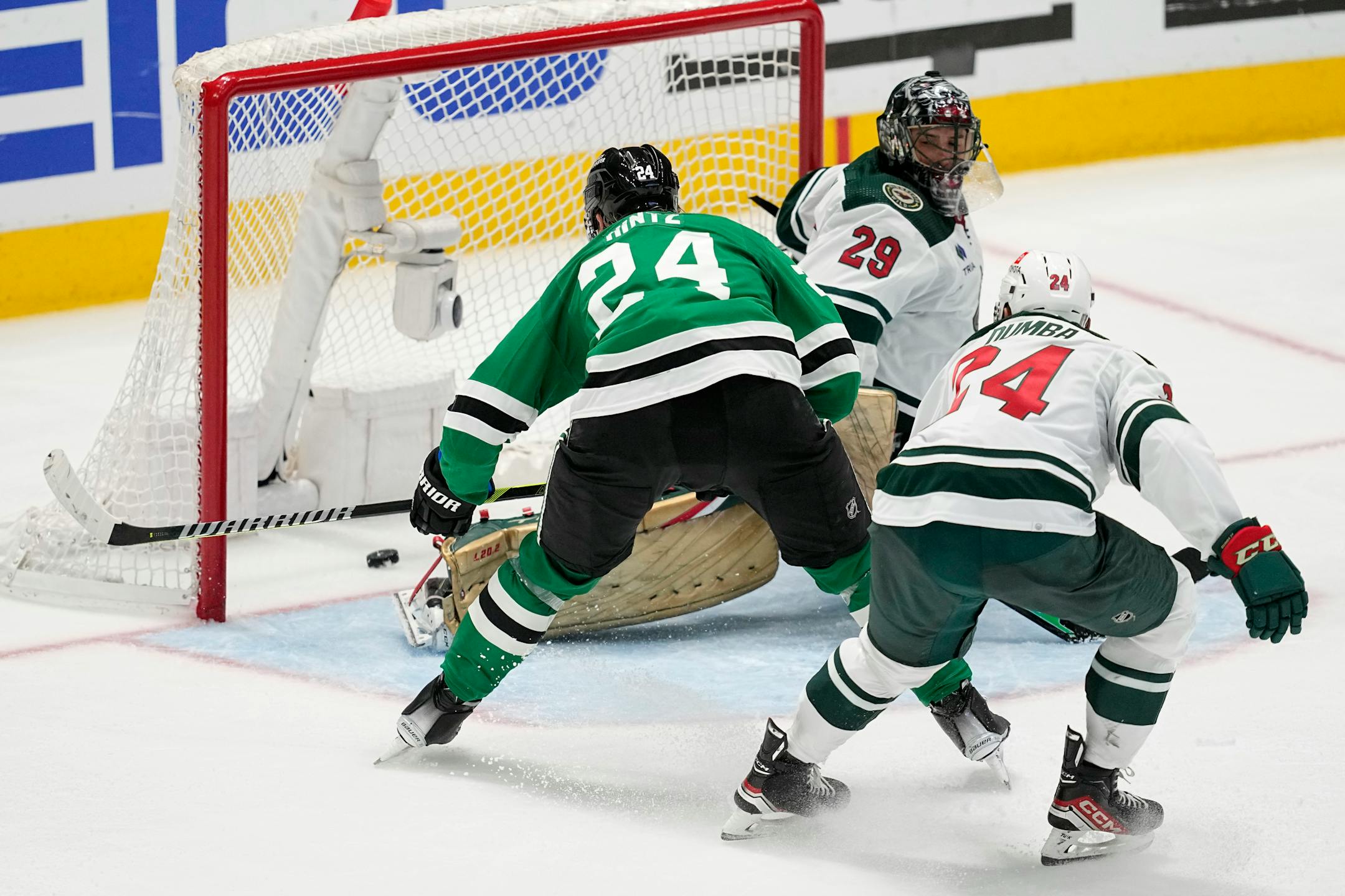 Dallas Stars center Roope Hintz (24) scores against Minnesota Wild goaltender Marc-Andre Fleury (29) as defenseman Matt Dumba, right front, looks on in the third period of Game 2. The goal was Hintz' third of the game.