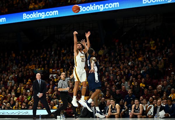 Gophers guard Gabe Kalscheur hit a 3-pointer against the defense of Penn State guard Myles Dread