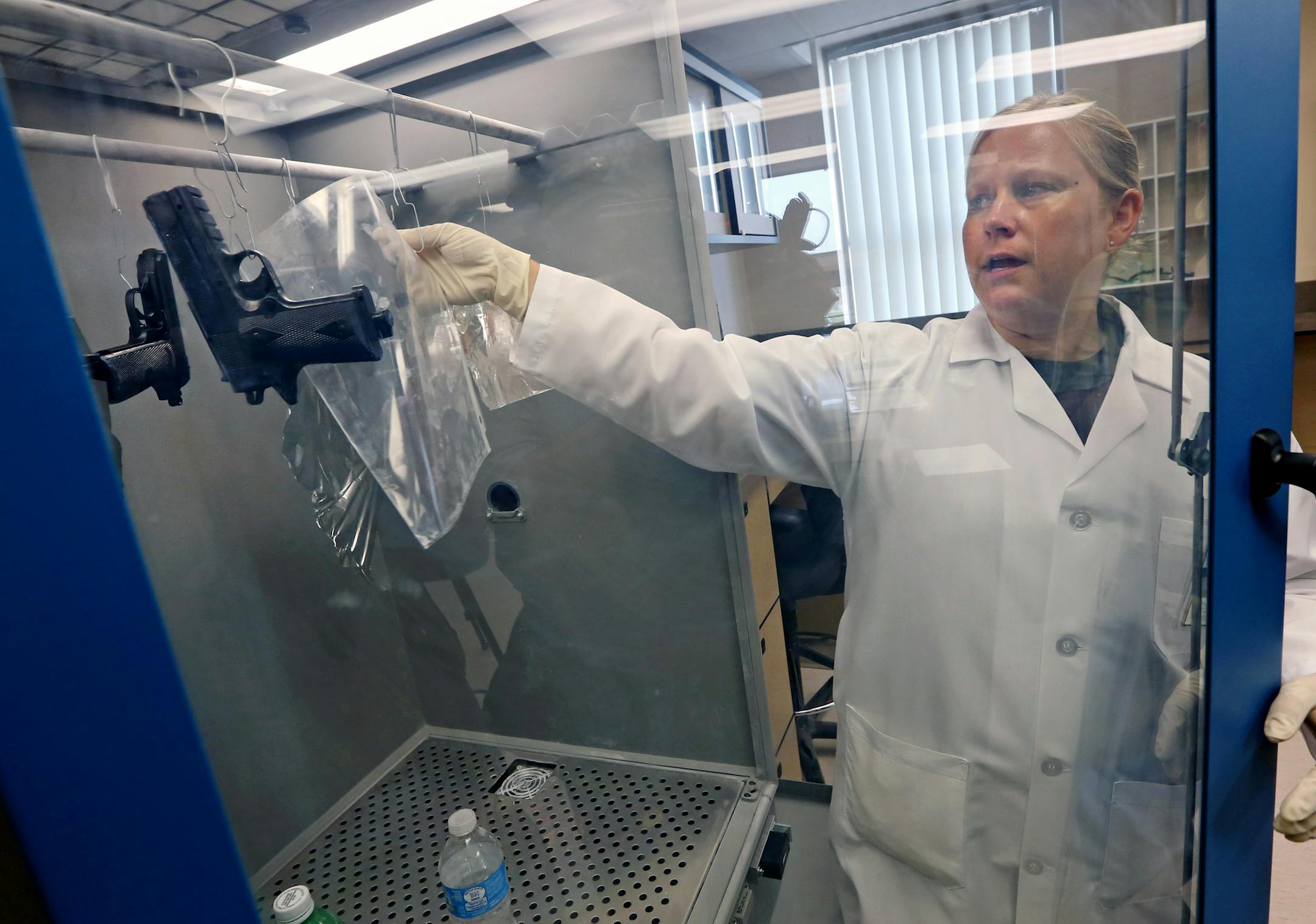 St. Paul Police Officer Alta Schaffer showed how a superglue fuming cabinet is used to find latent fingerprints on demonstration evidence during a tour of the St. Paul crime lab.
