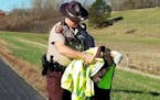 Trooper Paul Kingery secured the ailing eagle in his arms.