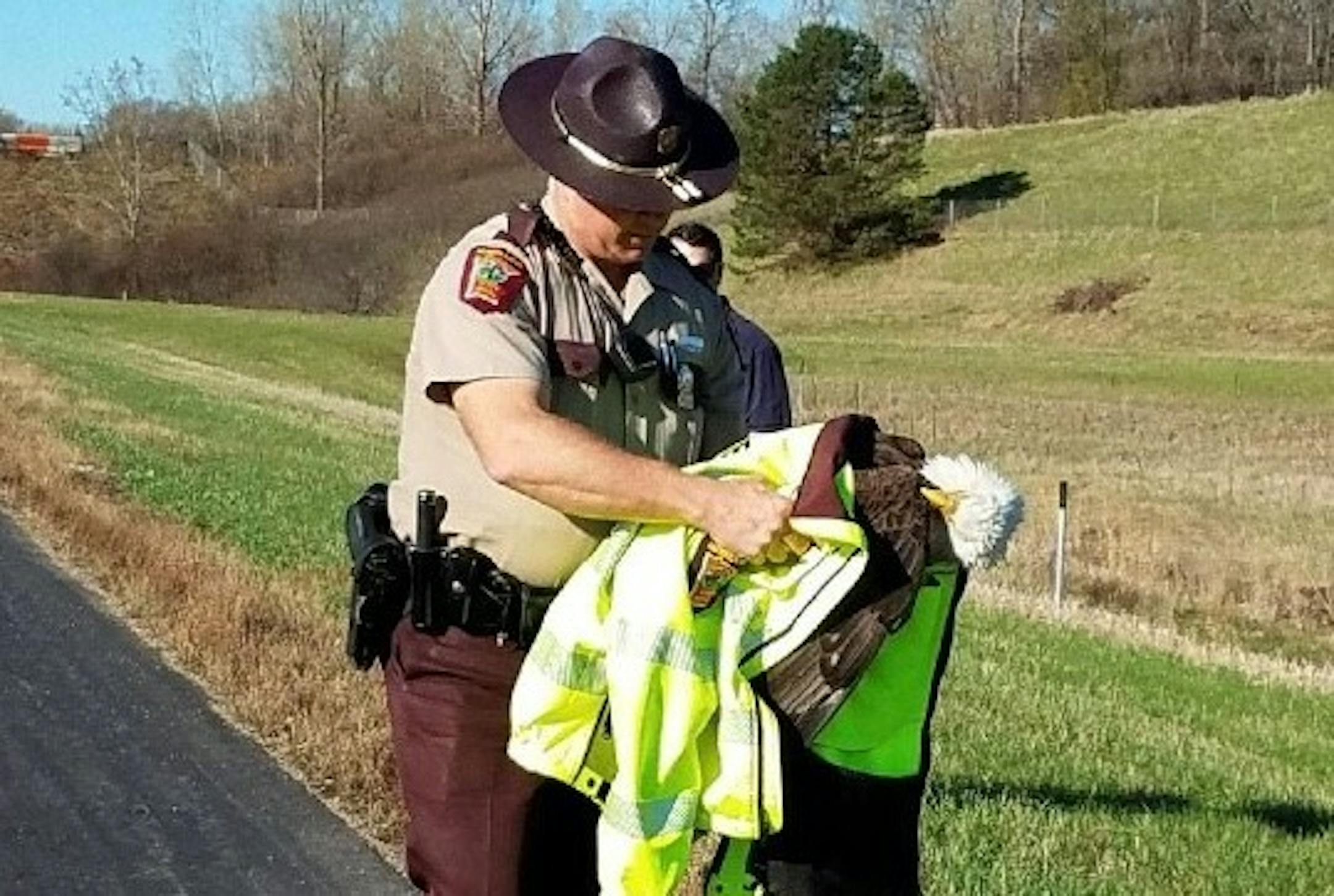 Trooper Paul Kingery secured the ailing eagle in his arms.