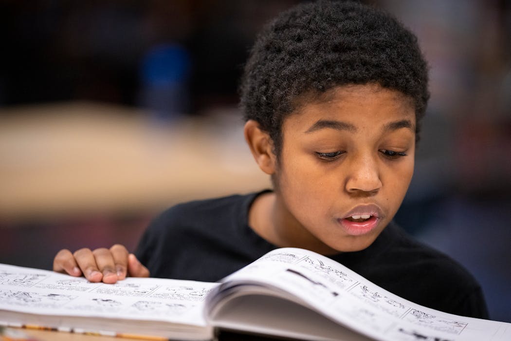 Sixth-grader Zayden Mcelveen read in the school library at Franklin STEAM Middle School in Minneapolis on Wednesday.
