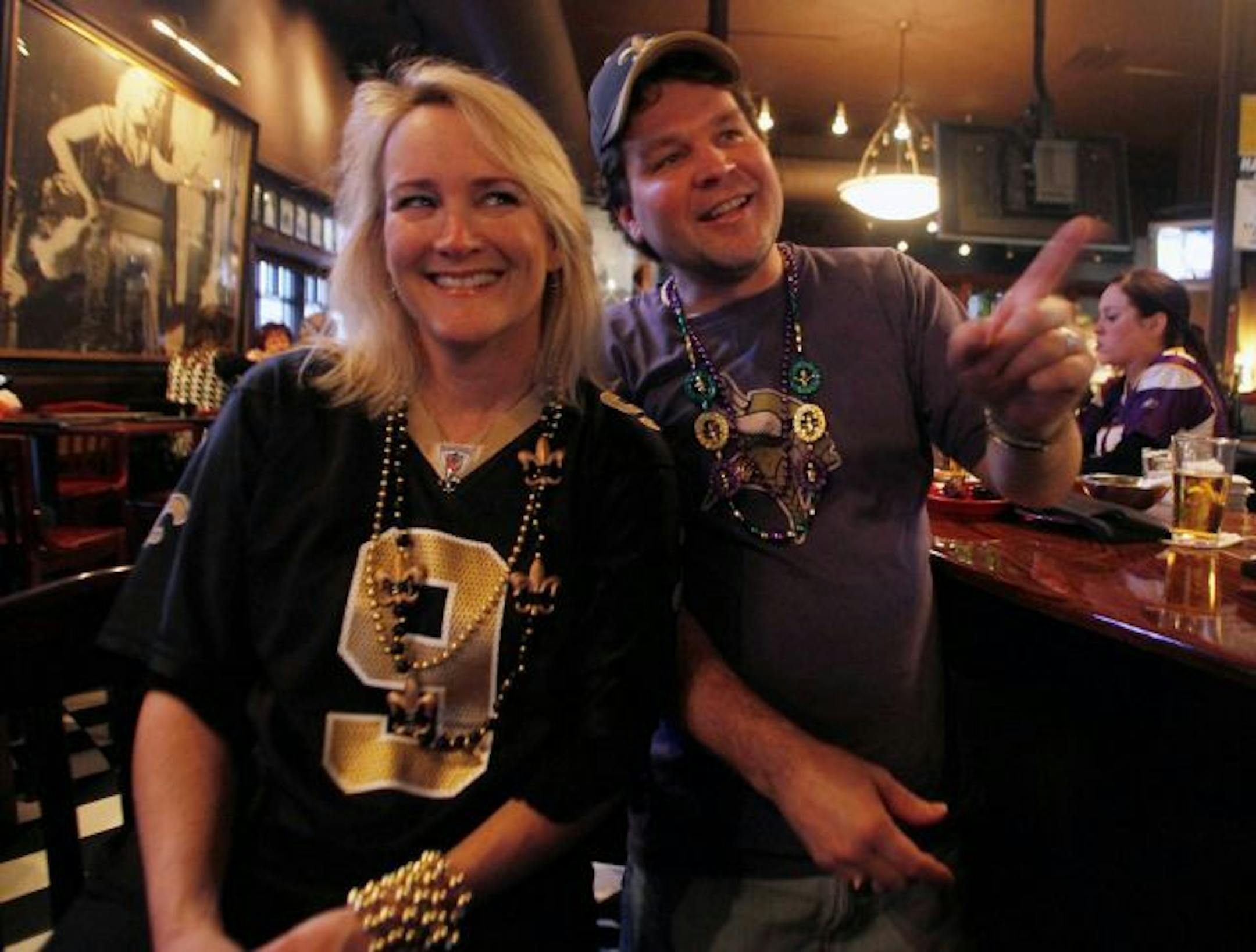Karen Kuebel, a Saints fan, and her husband, Michael Cameron, a Vikings fan, watched the game at Rudolphs Bar-B-Q in Minneapolis. Karen had the last laugh: the Saints won 31-28 in overtime.