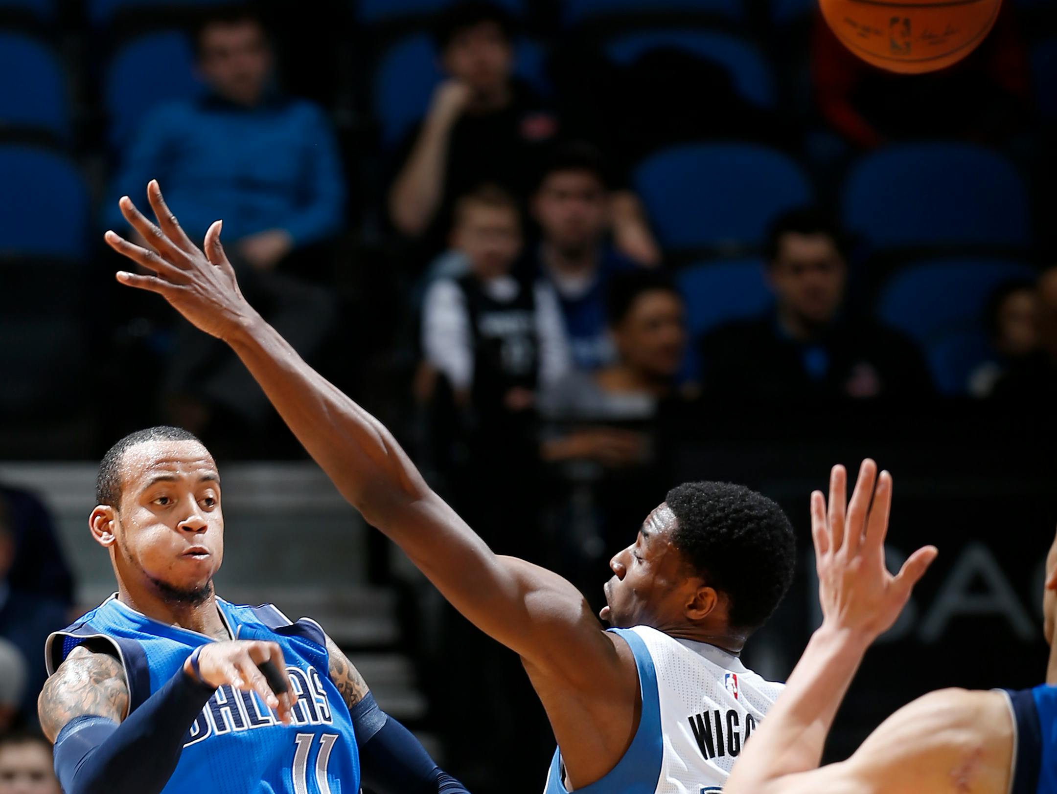 Monta Ellis (11) passed the ball to a teammate while being defended by Andrew Wiggins (22) in the first quarter.