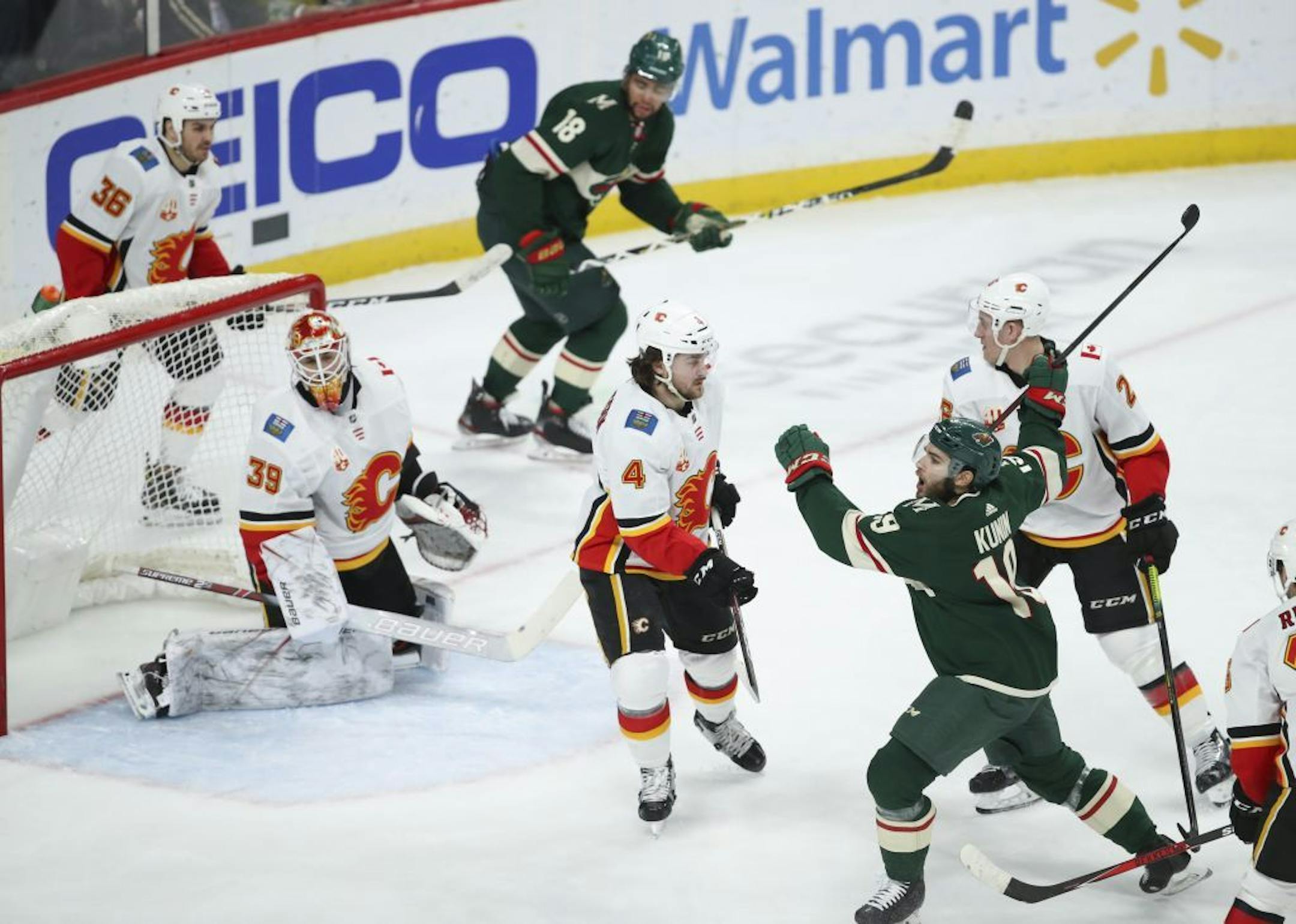 Minnesota Wild center Luke Kunin (19) celebrated his second period goal on Calgary Flames goaltender Cam Talbot (39).