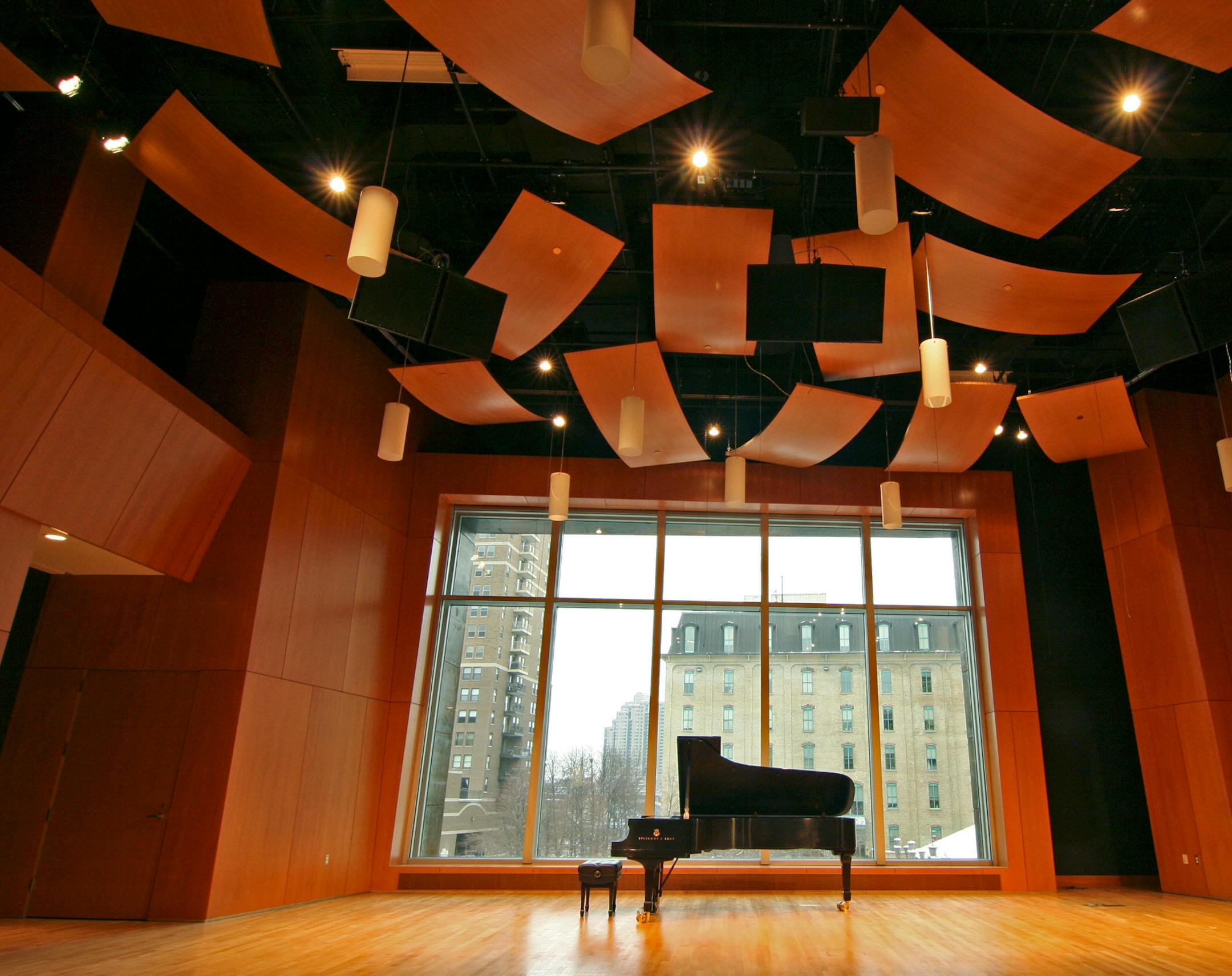 A two-story-tall window is the backdrop for Mac­Phail's new concert hall, paneled in Douglas fir and hung with curved, wooden acoustic "clouds" suspended from the ceiling.