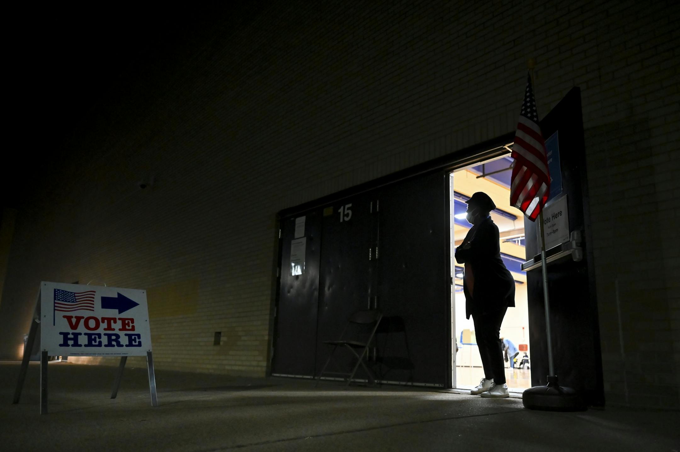 Tamara, no last name given, an election judge at North High School, looked outside for voters Tuesday night at North High School.