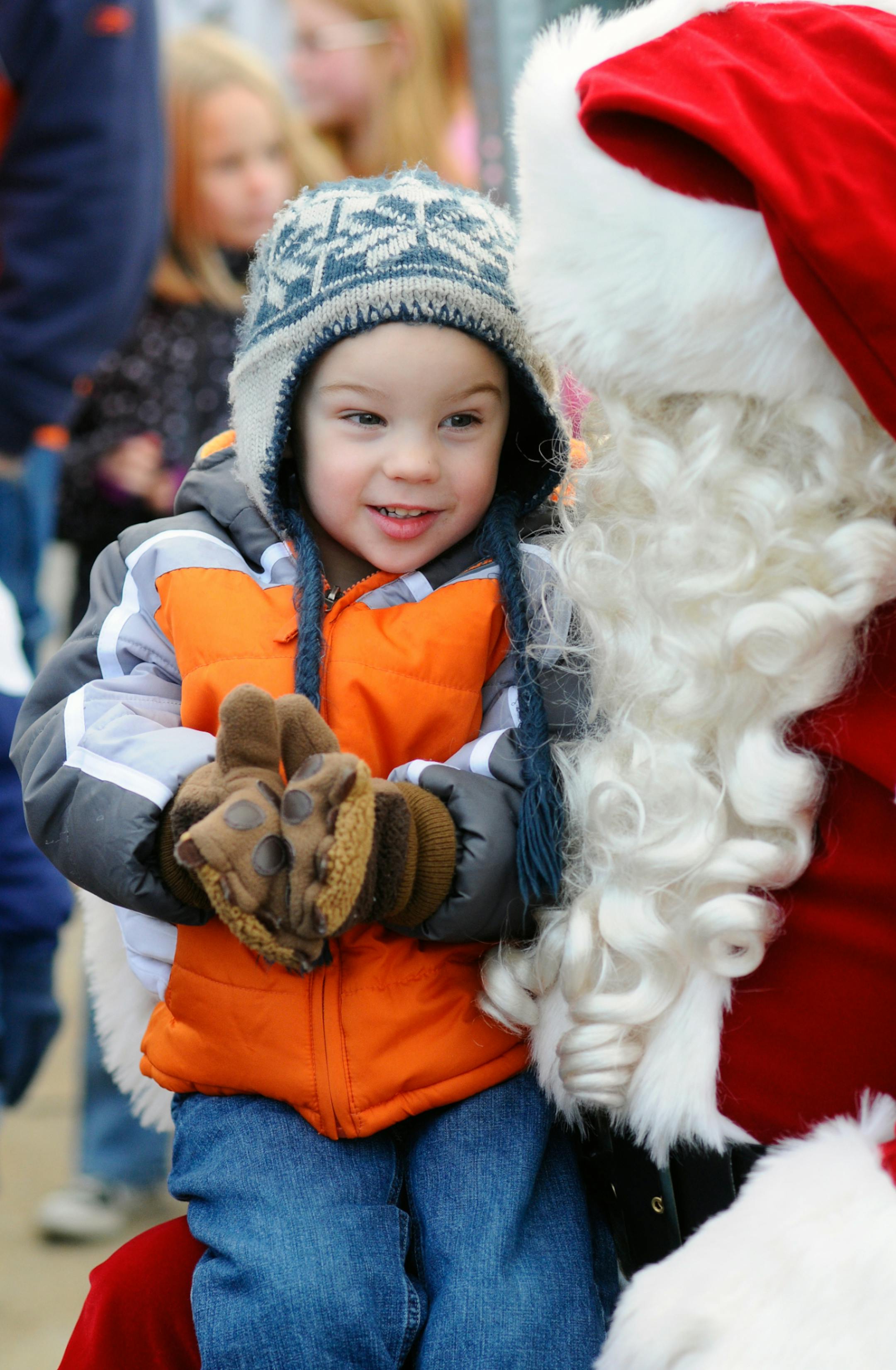 Easton Daubert, of Pine Grove, Pa. sits on Santa's lap during the Christmas Tree Lighting program in Pine Grove, Pa., Saturday, Nov. 23, 2013. (AP Photo/Republican-Herald, Jacqueline Dormer) MANDATORY CREDIT