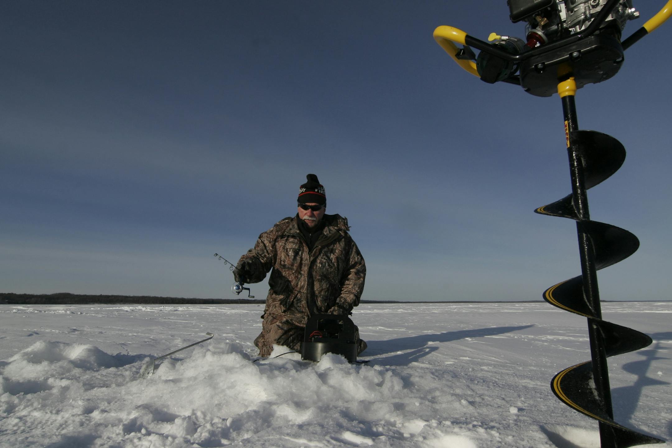 After drilling a hole in the ice, Jack Rendulich of Duluth fishes for perch on Leech Lake. The temperate was about 5 below zero, but the wind had died down, making it almost pleasnt on the big lake.