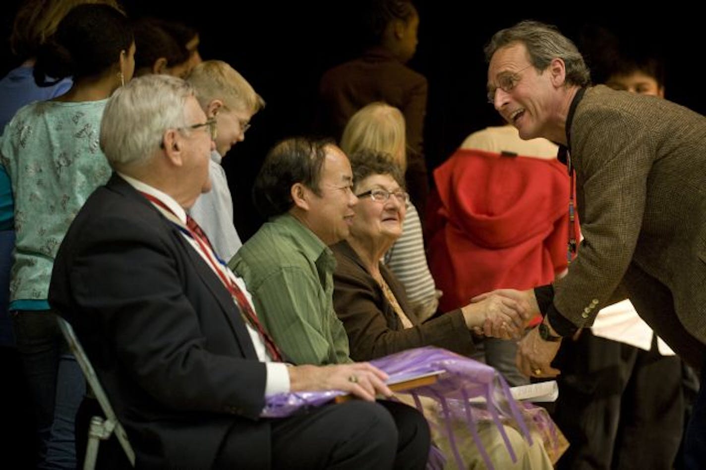 Larry Long greets the three "elders" after the performance. They are Malcolm Watson, Chong Kou Vang, and Fran Toler.