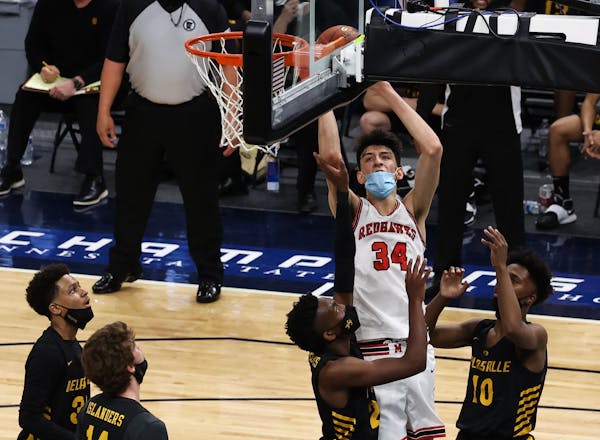 Minnehaha Academy's Chet Holmgren (34) scored from the low post over the heads of four DeLaSalle defenders in the first half Thursday of the Class 3A 