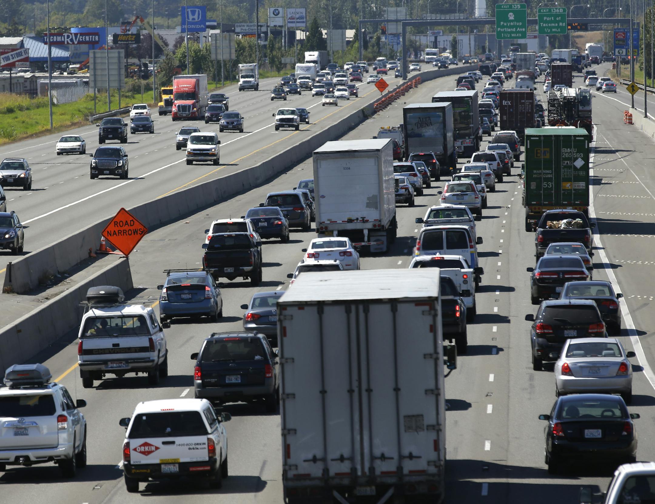 In this Wednesday, Aug. 24, 2016, photo, truck and automobile traffic mix on Interstate 5, headed north through Fife, Wash., near the Port of Tacoma. The federal government wants to limit how fast trucks, buses and other large vehicles can drive on the nationís highways. A new regulation posted Friday, Aug. 26, would impose the nationwide limit by electronically capping speeds with a device on newly-made U.S. vehicles that weigh more than 26,000 pounds. (AP Photo/Ted S. Warren) ORG XMIT: WA