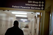 FILE - A sign points visitors toward the financial services department at a hospital, Friday, Jan. 24, 2014. More than a half million of the poorest A