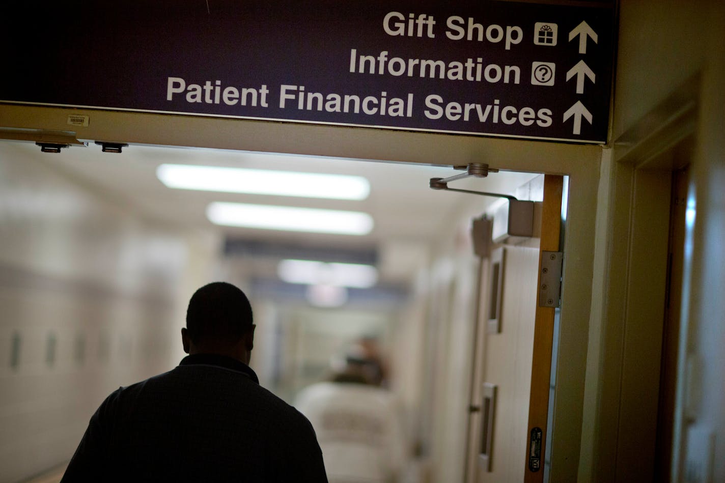 FILE - A sign points visitors toward the financial services department at a hospital, Friday, Jan. 24, 2014. More than a half million of the poorest Americans would be left without health insurance under legislation passed by House Republicans that would require people to work in exchange for health care coverage through Medicaid. The bill is unlikely to become law, though, with Democrats strongly opposing the idea. (AP Photo/David Goldman, File)