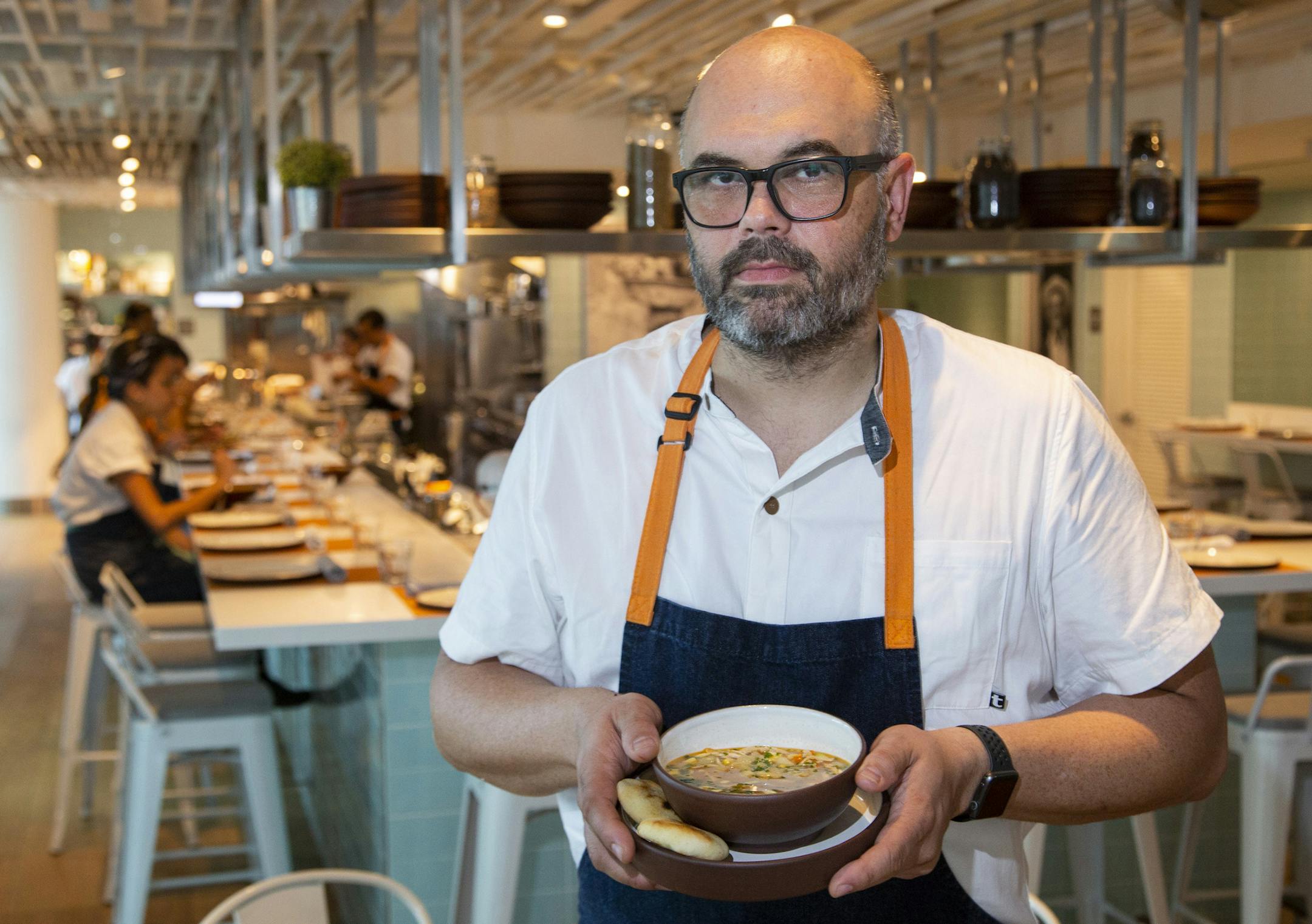 Venezuelan chef Carlos Garcia, prepared a chicken soup at his restaurant, Obra Kitchen Table, in Brickell, Fla., on Friday, Oct. 12, 2018. Garcia gives a portion of the proceeds from his chicken soup to a nonprofit that helps feed people in Venezuelan hospitals.