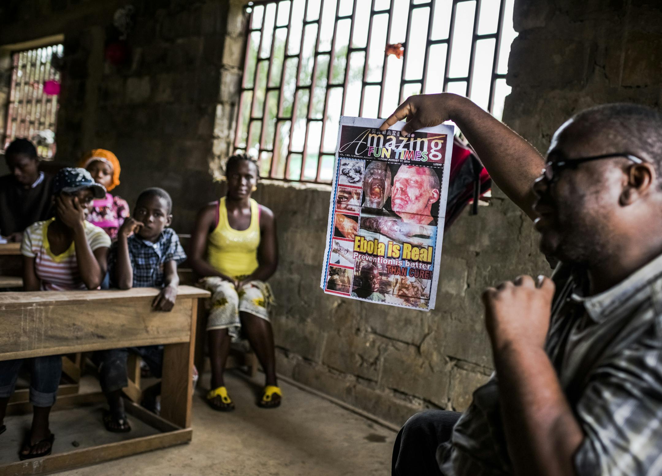 Dr. Mosoka Fallah, an epidemiologist and immunologist, speaks with residents during a neighborhood Ebola training session in Monrovia, Liberia, Aug. 30, 2014. Fallah, who grew up in Monrovia‚Äôs poorest neighborhoods before studying at Harvard, has been crisscrossing the capital in an effort to win the cooperation of residents who are deeply distrustful of the government and its faltering response to the deadliest Ebola epidemic ever recorded. (Daniel Berehulak/The New York Time