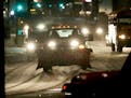 A pickup with a plow was gearing up for action as snow began falling Thursday morning near Broadway Ave. and I-94 in Minneapolis.