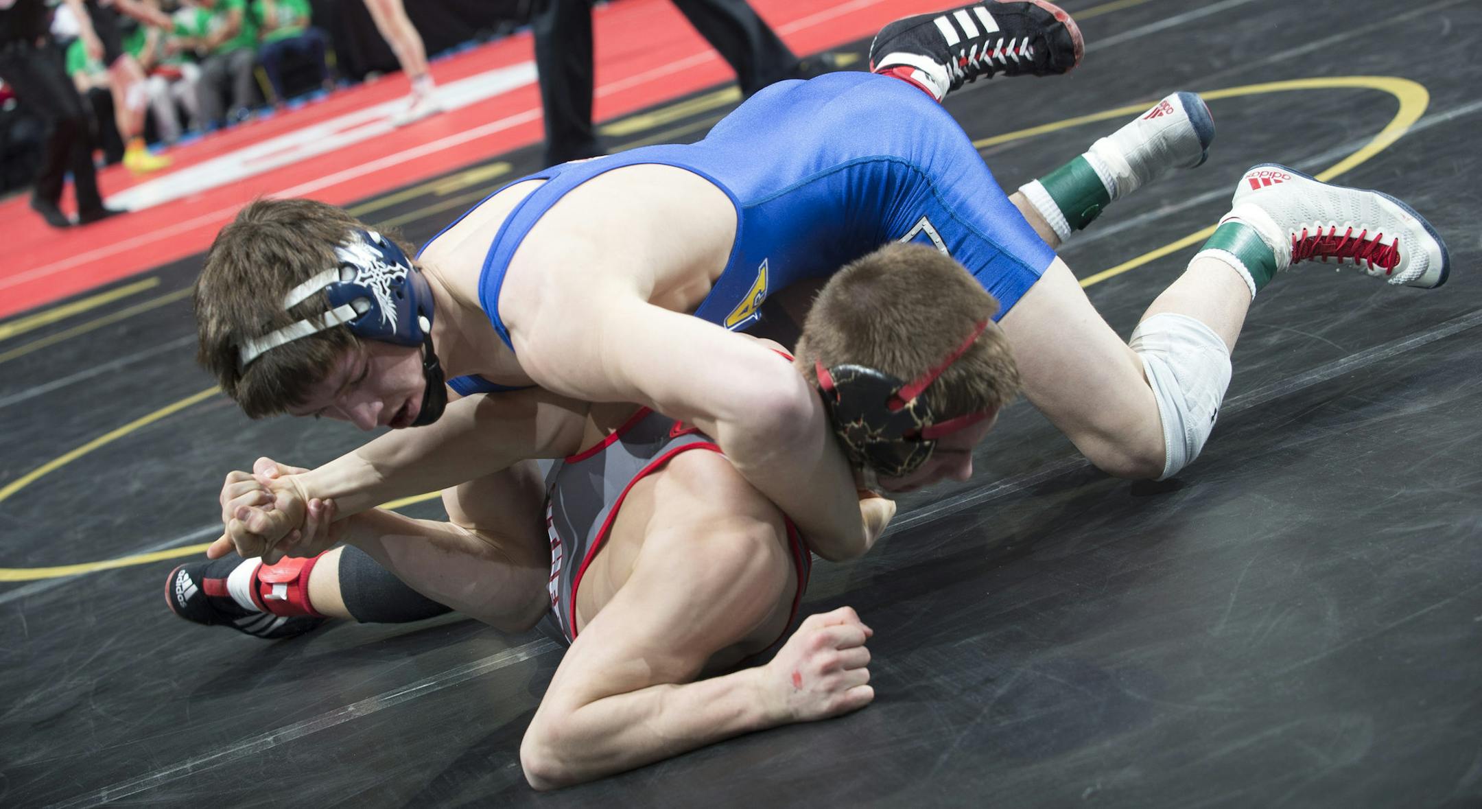 Mitchell McKee, back, of St. Michael-Albertville, tries to flip Wade Sullivan, of Lakeville North, to his back for a pin during the Class 3A prelims on Friday night in the 126 lb. weight class. ] (Aaron Lavinsky | StarTribune) Wrestlers compete in the Class 3A state wrestling individual prelims of the State Wrestling Tournament on Friday, Feb. 27, 2015 at Xcel Energy Center in St. Paul.