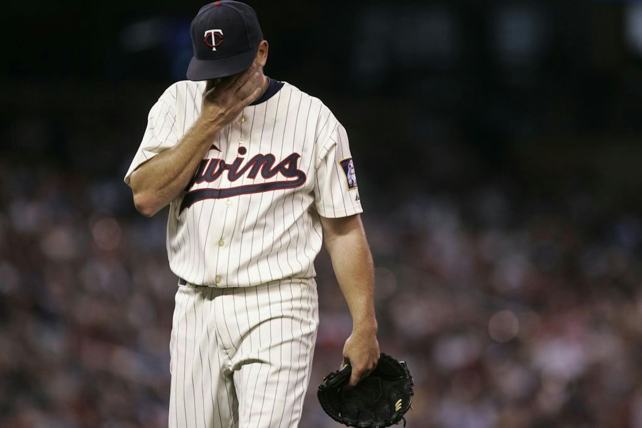 Twin Brian Duensing headed to the dugout after he gave up 4 runs in the second inning at the Target Field in Minneapolis, Minn., Tuesday, August 23, 2011. .