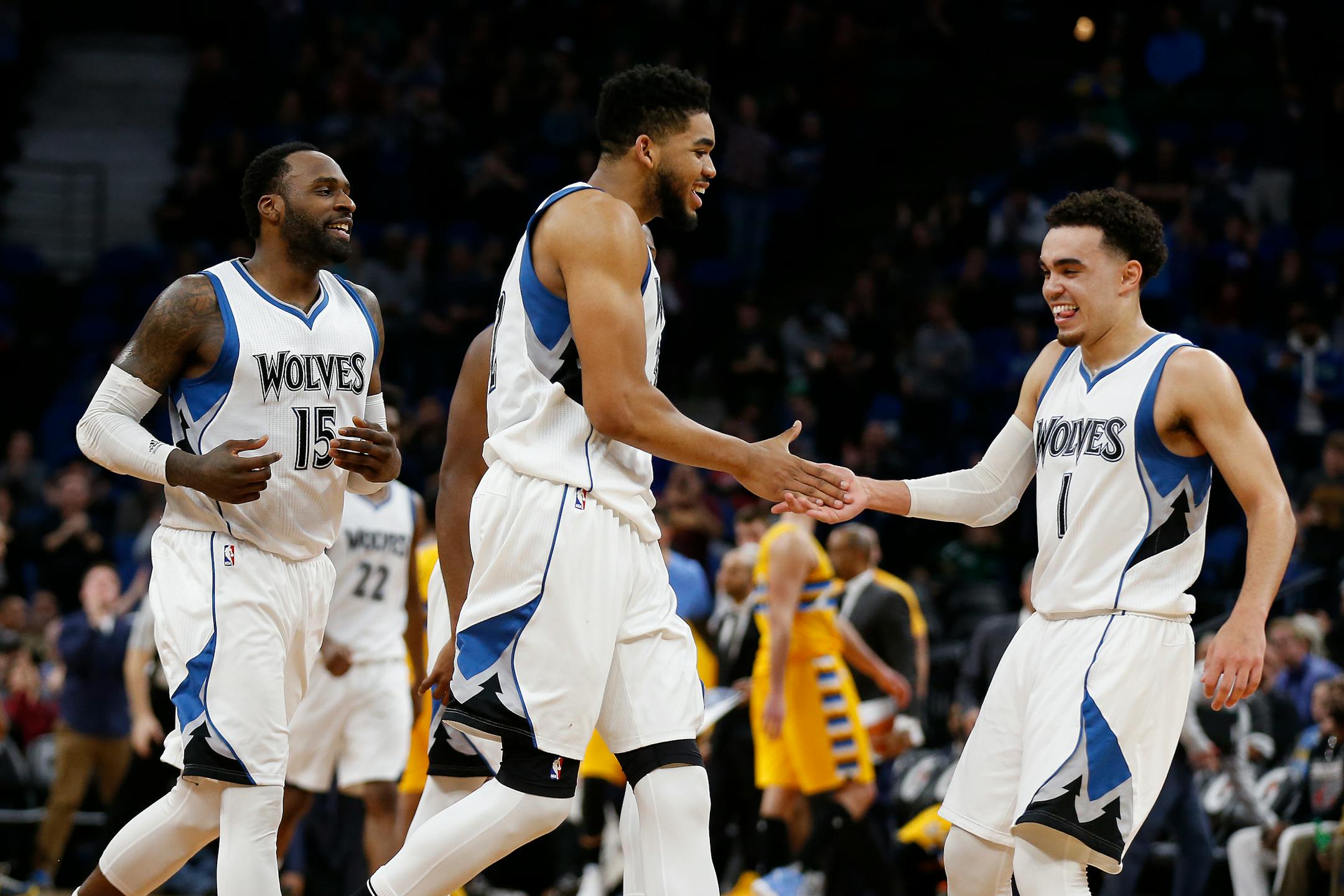 Minnesota Timberwolves teammates Karl-Anthony Towns, center, and Tyus Jones (1) celebrate their lead in the second half of an NBA basketball game Sunday, Jan. 22, 2017, in Minneapolis. The Wolves won 111-108. (AP Photo/Stacy Bengs)